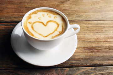 Cup of coffee latte art on wooden background