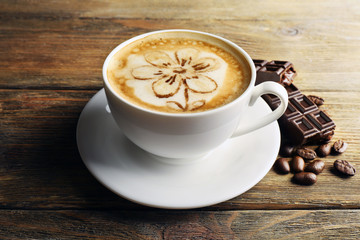 Cup of coffee latte art with grains and chocolate