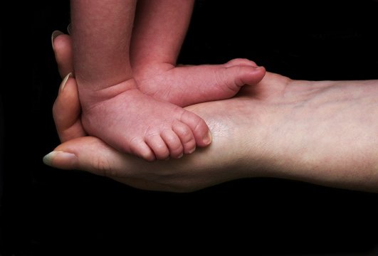 Baby Feet In Mothers Hand