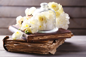 Beautiful composition with flowers and old books
