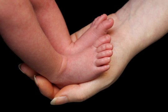 Baby Feet In Mothers Hand