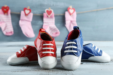 Cute toddler shoes and socks on wooden background