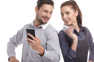 Attractive couple using their smartphones on white background