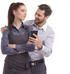 Attractive couple taking a selfie together on white background