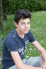 Teenager is posing outside in the garden