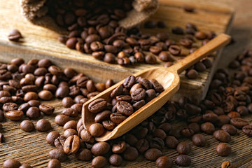 Coffee beans on wooden table, closeup