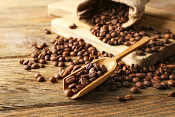 Coffee beans on wooden table, closeup