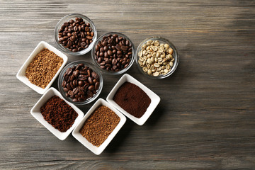 Coffee beans in saucers on wooden background
