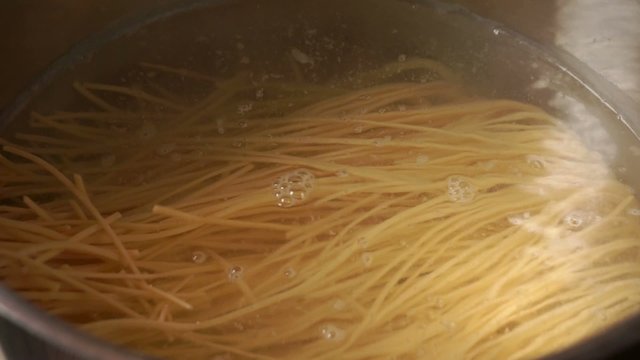 Spaghetti in a pan of boiling water