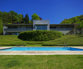 Outside of modern house in summer, swimming pool