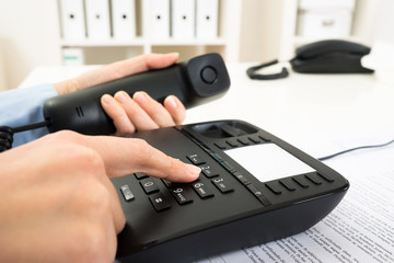 Businessperson Dialing Number On Telephone Keypad