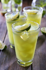 Glasses of cocktails on wooden table, closeup