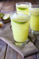 Glasses of cocktails on wooden table, closeup