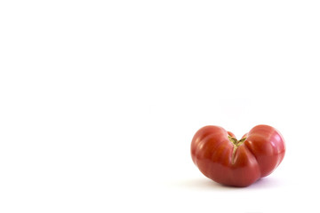 tomato in heart shape on white background