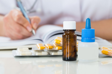 Doctor Writing Prescription On Clipboard