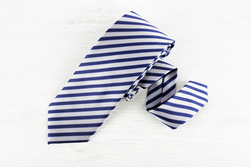 Striped tie on wooden table background