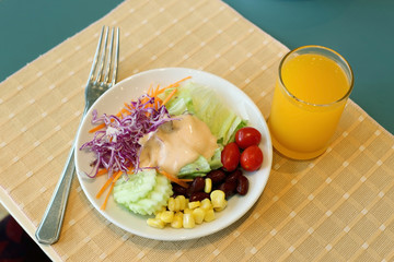 Healthy breakfast set, Fresh vegatable salad and orange juice.