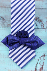 Male necktie and bow tie  wooden background