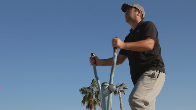 Young man exercising on cross trainer