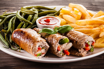 Wrapped pork chop, chips and vegetables