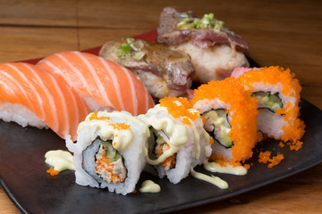 Japanese sushi roll served on a black plate