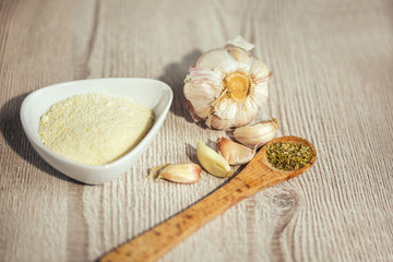 Obraz na płótnie Canvas Garlics,parmesan, oregano on table wooden background