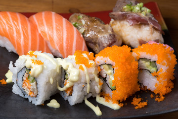 Japanese sushi roll served on a black plate