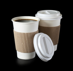 Paper cups of coffee on black background
