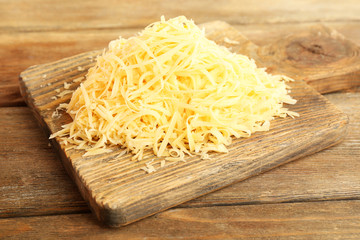 Grated cheese on wooden background