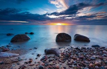 Beautiful rocky sea shore at sunrise or sunset.
