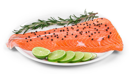 Raw salmon fillet on white plate.