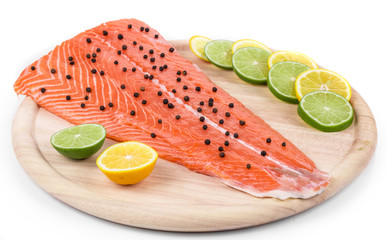 Raw salmon fillet on platter.