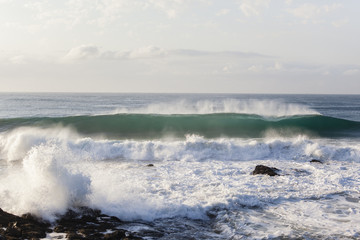 Wave Swells Crashing Rocky Coastline