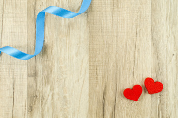 Heart and ribbon on wooden background