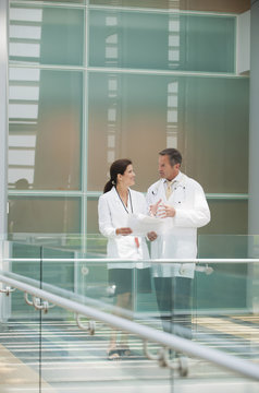 Doctors talking together near hospital railing