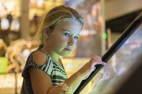 Caucasian girl using touch screen