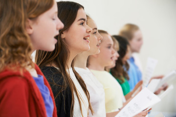 Group Of School Children Singing In Choir Together - obrazy, fototapety, plakaty