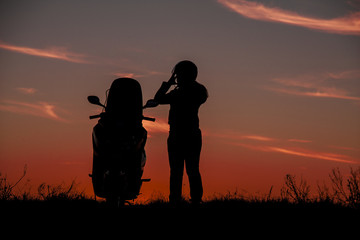 Silhouette motorbike and biker women