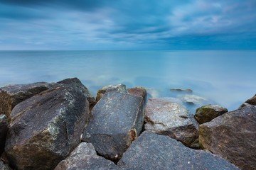 Fototapeta na wymiar Beautiful Baltic sea landscape with stone breakwater.