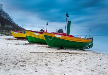 Naklejka na ściany i meble Landscape with Baltic Sea. Fishing boat on the beach. 