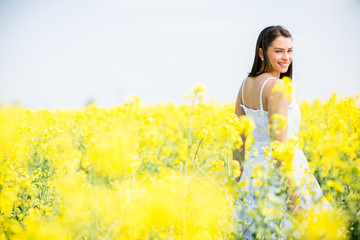 Fototapeta premium Young woman in the spring field