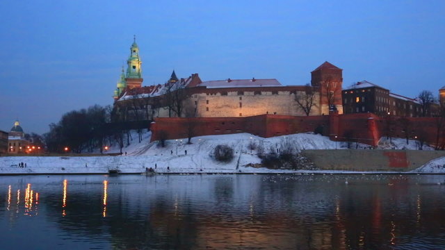 Wawel castle and the Vistula River in Krakow in winter night