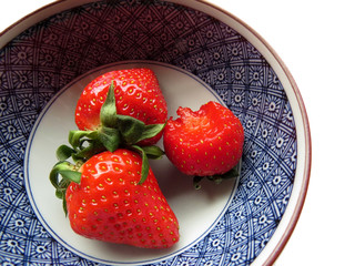 Three strawberries in a bowl