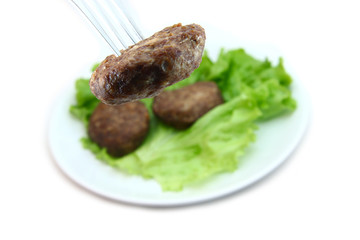 veal cutlet with lettuce on white background