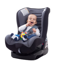 Adorable smiling happy child sitting in a car seat