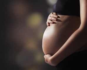 Pregnant woman touching her belly