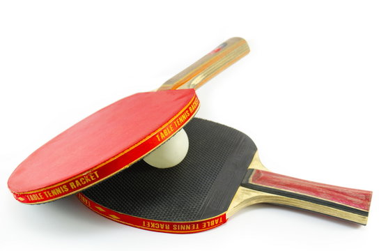Two table tennis rackets and a ball isolated