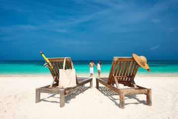 Couple in white running on a beach at Maldives