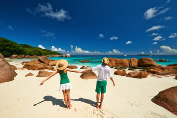 Couple in green having fun on a beach at Seychelles