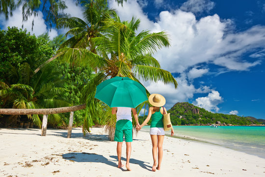 Couple in green on a beach at Seychelles